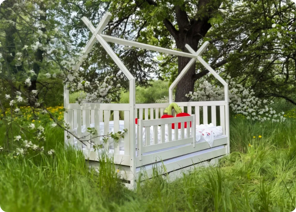 Cotton tipi bed standing in a clearing among blooming trees
